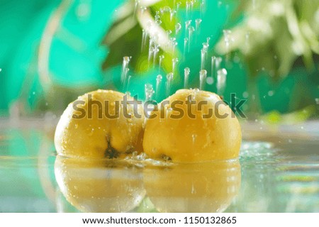 Apples in the water. Yellow apples fall in water.Water background leaves of tree apples, in the nature.
