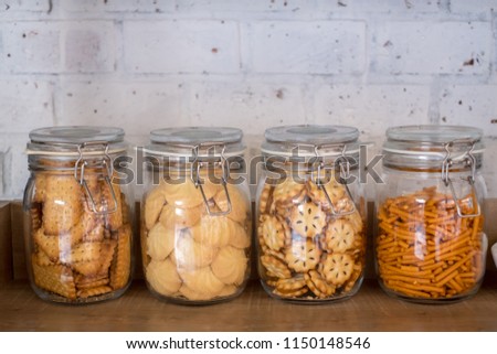 Snack and Biscuit in Kitchen Canisters & Jars with brick wall background