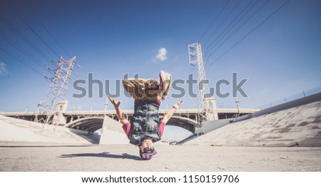 Two bbys ding some stunts - Street artist breakdancing outdrs Royalty-Free Stock Photo #1150159706