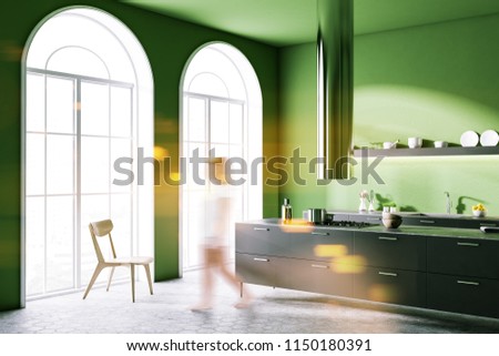 Woman walking in the corner of a modern kitchen interior with green walls, a gray floor, arched windows and white countertops. 3d rendering mock up toned image blurred