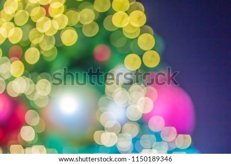Abstract blurred colorful Christmas tree lighting decoration with bokeh background. Defocused of decorated and illuminated christmas tree for Merry Christmas and new year festival celebration. Royalty-Free Stock Photo #1150189346