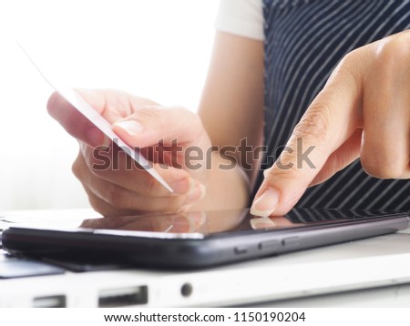 Hands holding credit card and using laptop. Online shopping
