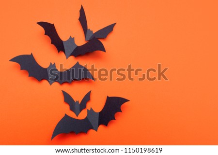 Happy Halloween. Festive background. Lots of bats on bright orange background