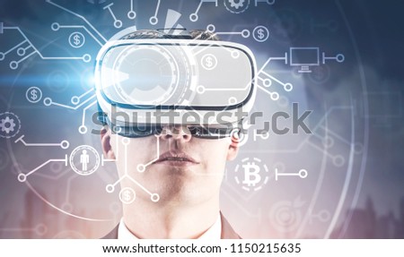 Young businessman in VR glasses. HUD interface and infographics, bitcoin icons. Hi tech innovation and mining, blockchain concept. City background. Toned image double exposure