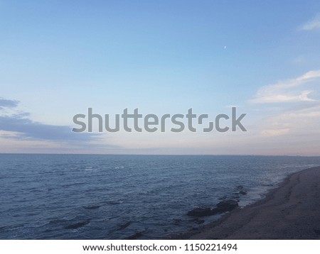 dying light with the moon over the sea