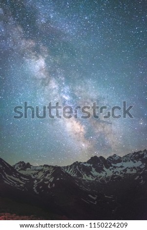 landscape Milky Way on the night sky over a chain of mountain ranges background
