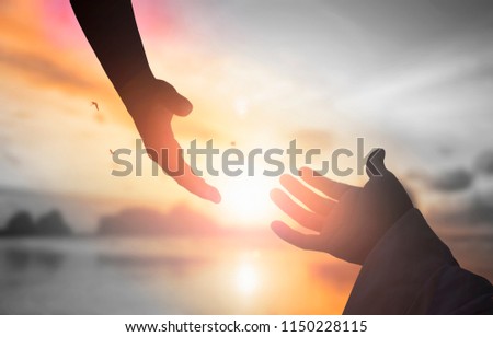 The concept of God's salvation:silhouette of helping hand concept and international day of peace Royalty-Free Stock Photo #1150228115