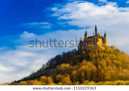Medieval old historic middle age castle palace for king, queen, prince, princess, noble on top of the mountain in europe under blue sky during family holiday and honey moon couple vacation retreat