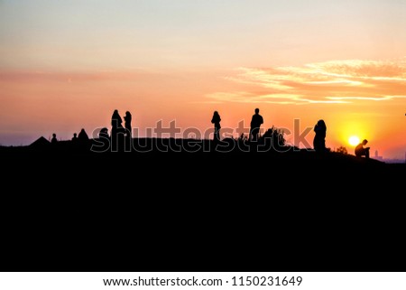 people climbed the hill to enjoy the sunset