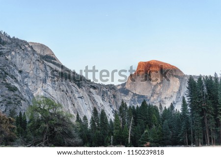 The setting sun casting it's last rays onto Half Dome, in Yosemite National Park.