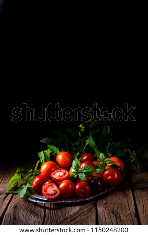 various types of tomatoes served and presented on the silver platter.