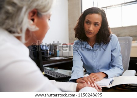 Concerned female analyst counselling senior patient Royalty-Free Stock Photo #1150248695