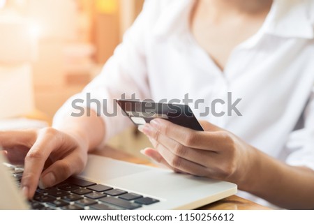 Young asian women hands holding credit card for online shopping at home,teenager owner business,success and online shopping concept.
