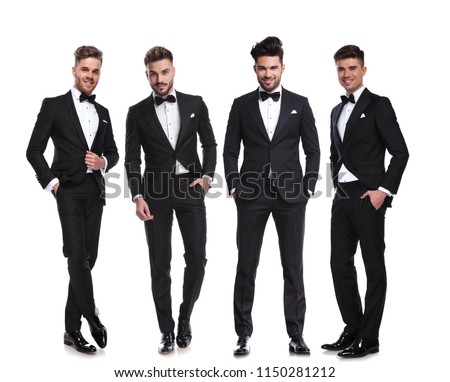 elegant group of four men standing on white background with hands in pockets, full body picture Royalty-Free Stock Photo #1150281212