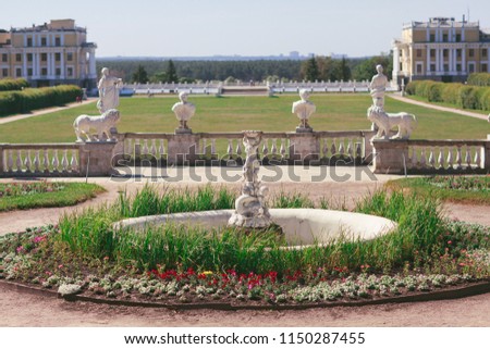 Green garden with stone statues