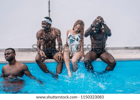 African friends play in the pool happy.