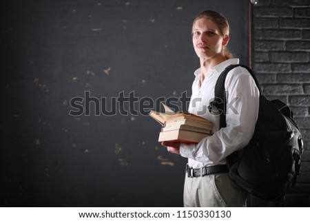 Adult student with long hair and a backpack with books
