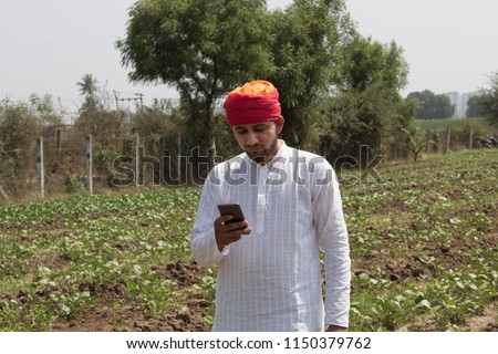 Farmer using mobile phone Royalty-Free Stock Photo #1150379762