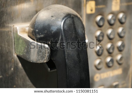 Old public pay phone with dust