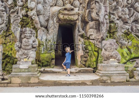 Boy tourist in Old Hindu temple of Goa Gajah near Ubud on the island of Bali, Indonesia. Travel in Bali with children concept