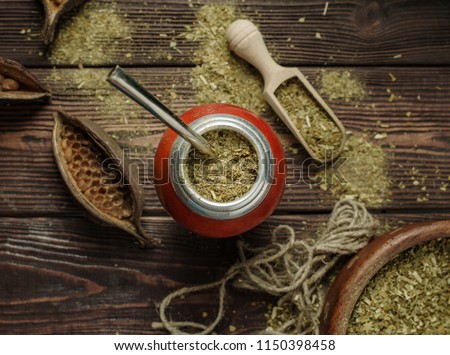 Mate yerba tea in calabash on wooden table. Traditional argentinian beverage. Royalty-Free Stock Photo #1150398458