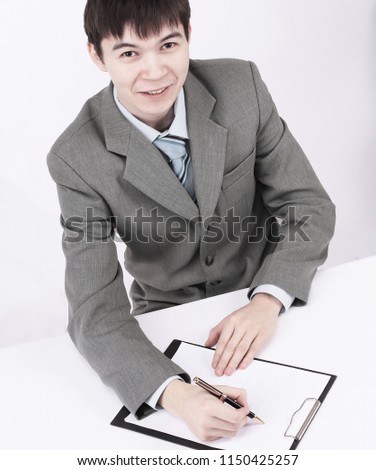 businessman reading a contract sitting behind a Desk