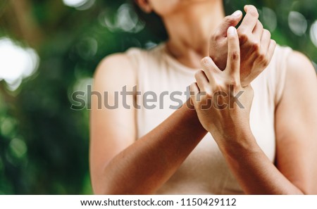 Close up Woman wrist pain , office syndrome , health care concept Royalty-Free Stock Photo #1150429112