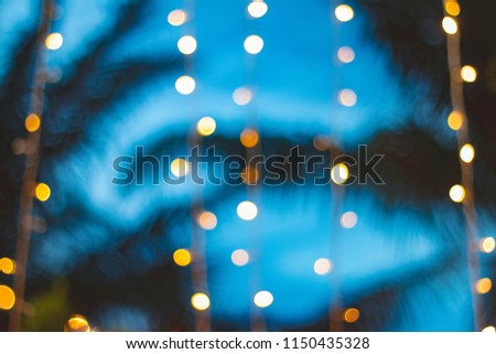 blurred light bokeh with coconut palm tree background on sunset