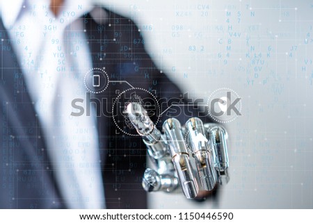 Businessman With Artificial Robotic Hand working on virtual holographic interface