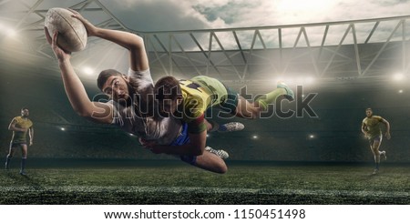 Rugby players fight for the ball on professional rugby stadium Royalty-Free Stock Photo #1150451498