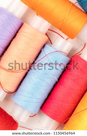 An overhead closeup photo of vibrant sewing thread spools