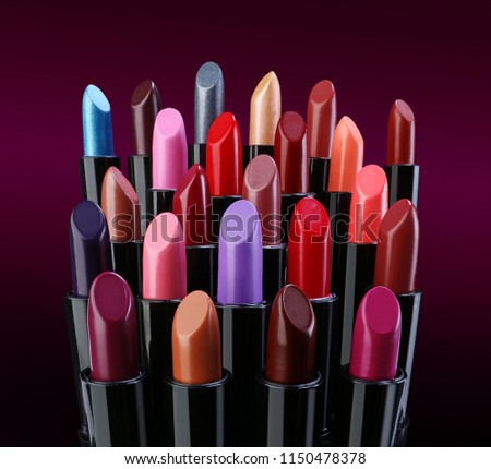 Group of various fashion lipsticks over dark background
