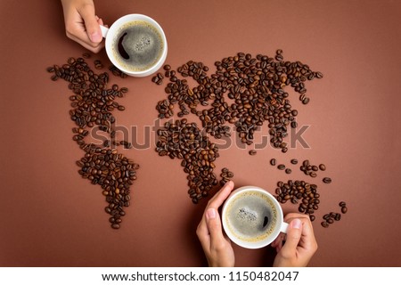 Map of the world made of roasted coffee beans on brown paper background. International coffee industry or travel planning concept Royalty-Free Stock Photo #1150482047
