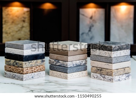 Kitchen counter top color samples made of natural granite, marble and quartz stone inside the countertop store on the white carrara marble slab Royalty-Free Stock Photo #1150490255