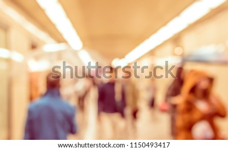 Abstract Blurred image of People walking at hallway with bokeh  for background usage. (vintage tone)