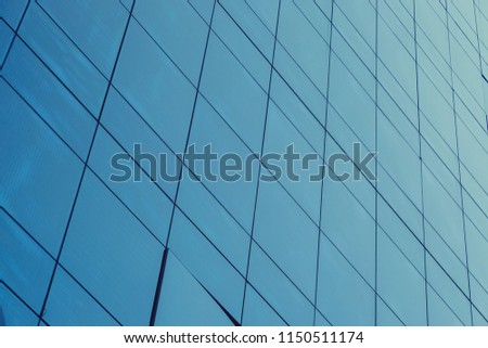 Blue glass windows of modern office building for save energy