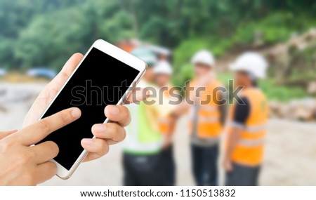 woman use mobile phone and blurred image of the manager and engineers in the construction work site