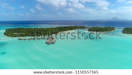 Water bungalows resort at islands, french polynesia in aerial view