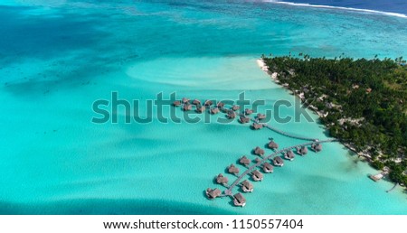 Water bungalows resort at islands, french polynesia in aerial view