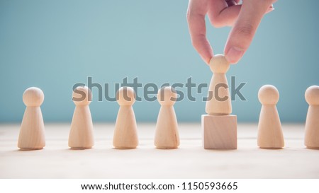 Successful team leader, Businessman hand choose people standing out from the crowd. Royalty-Free Stock Photo #1150593665