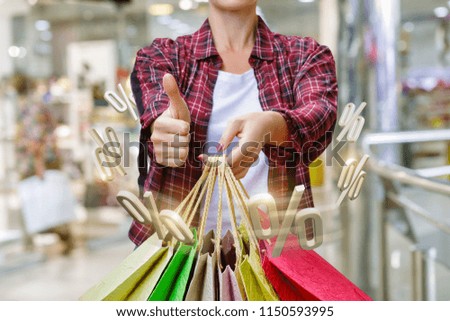 Shopper showing interest with shopping on blurred background.