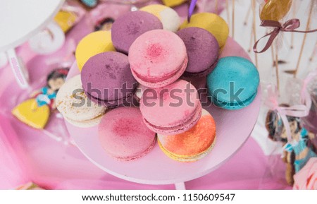multicolored macaroons on a children's holiday. decoration of holidays and children's parties close-up