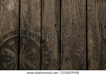 drawing of a compass on a vintage wooden background. Travel concept