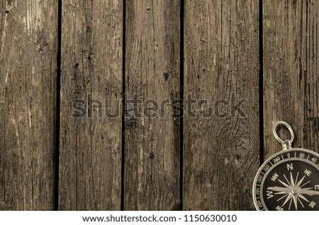 Compass on an old wooden background. Adventure and travel concept. Copy space