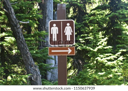 A washroom sign in a trail