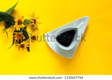 vintage white ceramic cup with coffee. Creative  background with flowers of marguerite on yellow texture-color of the year 2019,closeup, copy space