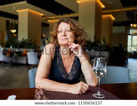 woman drinking water in a restaurant