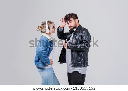 Portrait of a young couple enjoying music over white background