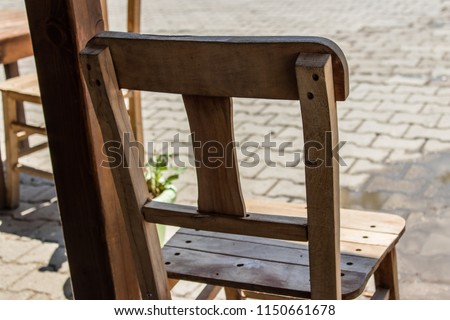 an object portrait from old wooden chair. photo has taken from an urban street.