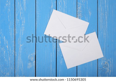 Postage and packing service - Two Envelope on a blue wood plank background.